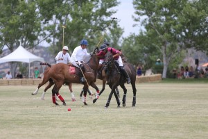 Members of the Platinum Performance and Happy Canyon Vineyard teams fight for the ball at the recent Santa Ynez Valley Polo Classic.  The Classic, attended by more than 650, is a fundraiser for People Helping People.