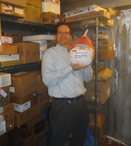 Mike Hendrick, Marriott General Manager, places the first turkey donated to PHP for Thanksgiving, 2014 in freezer space donated to PHP by the Santa Ynez Valley Marriott. PHP will need to store up to 300 turkeys prior to November 27th.