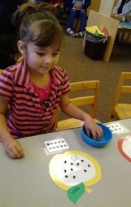 Student at the State Preschool in Santa Ynez works on a visual math project to improve her knowledge of numbers, specifically groups of 10.