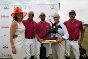 People Helping People Vice President, Michael Balaban, (center-right) hands 2014 Polo Classic Winner’s Trophy to T.J. Barrack (center-left) of the Happy Canyon Vineyards Polo Team. 