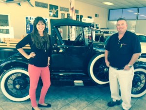 Erica Valdés, People Helping People’s (PHP) Associate Development Director, (left) and Dan Vreeland, Vreeland Ford Partner, pose with the Model “A” Ford truck that they hope people will fill with food during the Fill The Truck Food Drive.  Food collected will go to PHP to help feed those in need during the holidays.