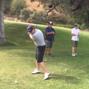Justin Wilkins of People Helping People’s Golf Team tees off at the first hole in the 2015 Marriott Miracles Happen Golf Tournament.